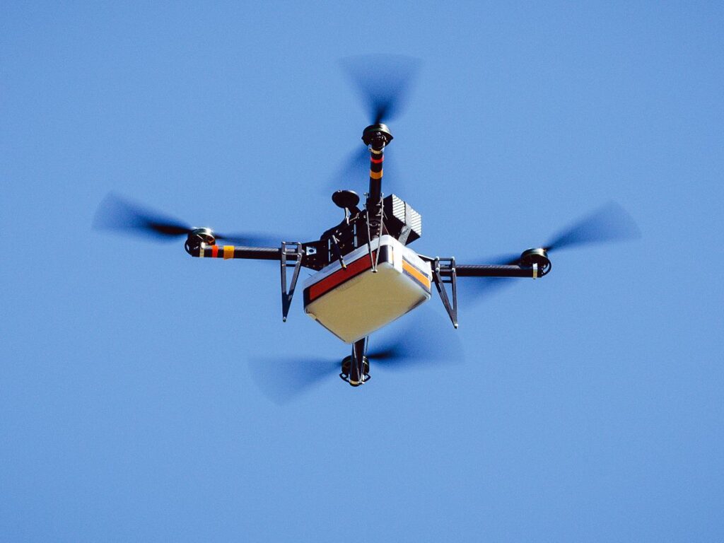 Autonomous UAV delivery cargo drone flying during an edge AI-powered logistics mission